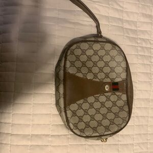 A authentic Gucci wristlet. Used with love.